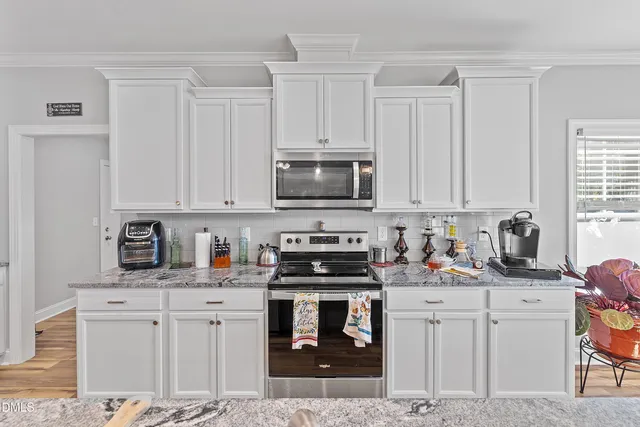 a kitchen with lots of counter top space a sink and appliances