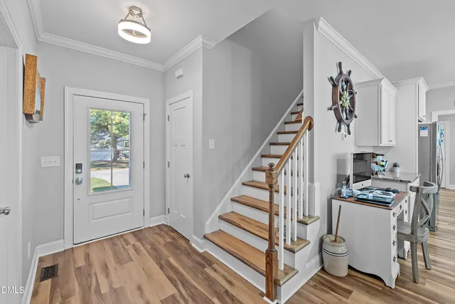 a dining room filled chandelier and kitchen view