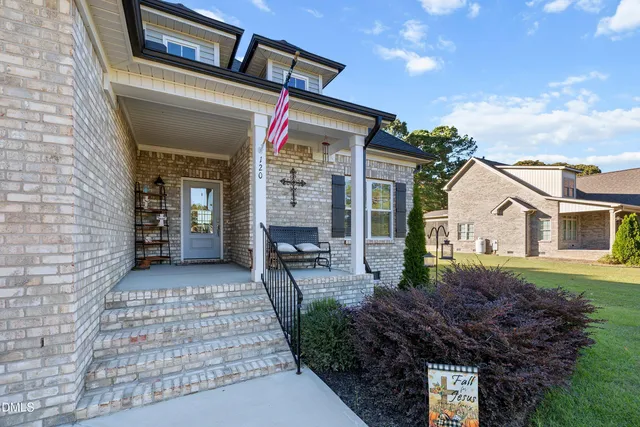 a picture of a room with a white wall and white refrigerator