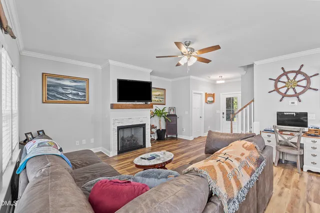 a living room with furniture a fireplace and a flat screen tv