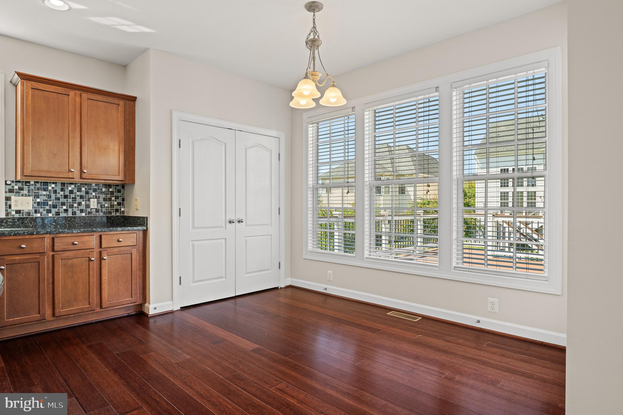 16862 Reef Knot Way Woodbridge, VA 22191 - Photo 19 of 99 a view of an empty room with wooden floor and a window