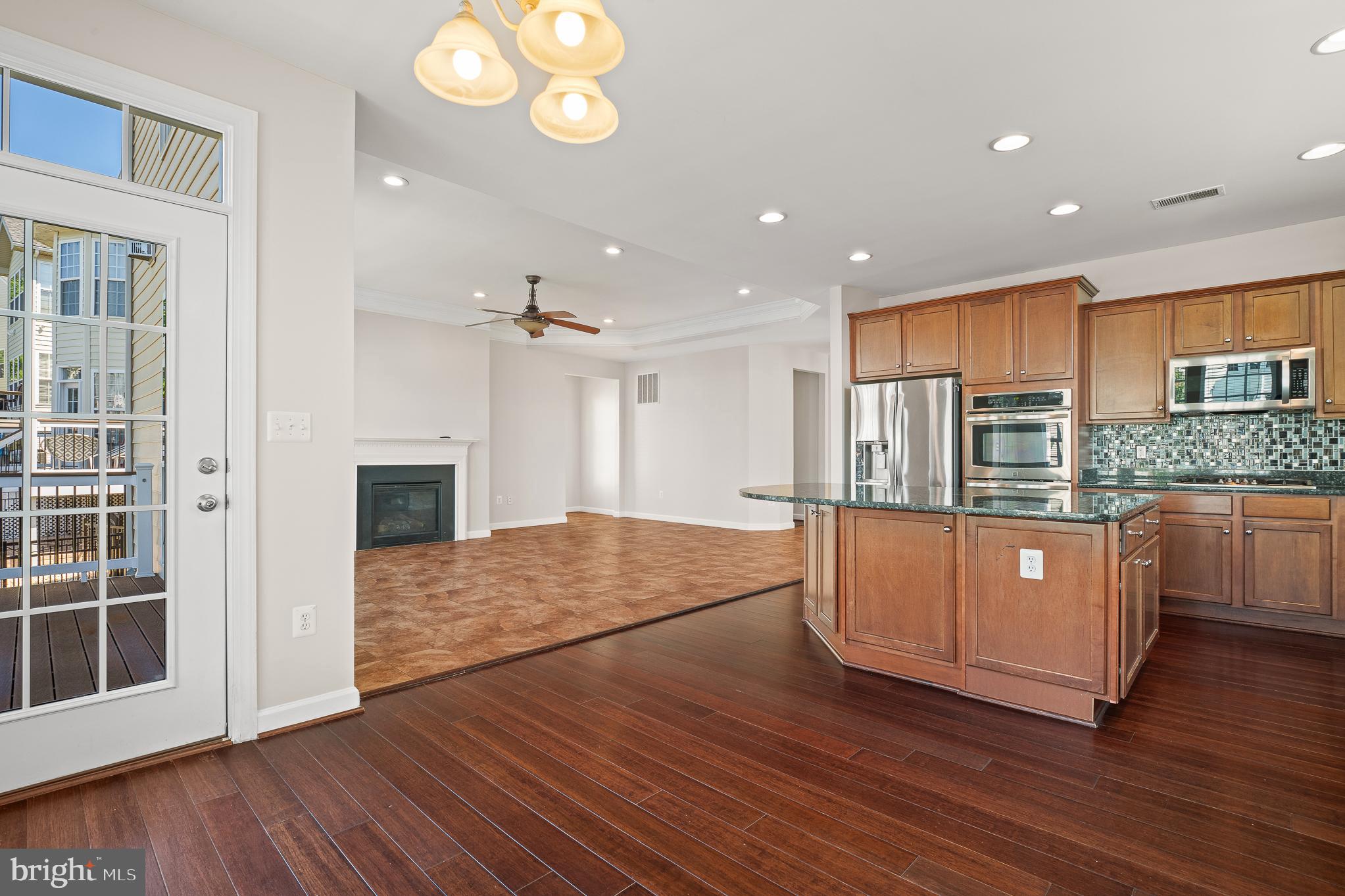 16862 Reef Knot Way Woodbridge, VA 22191 - Photo 20 of 99 a large kitchen with stainless steel appliances granite countertop a large cabinets a oven and a wooden floor