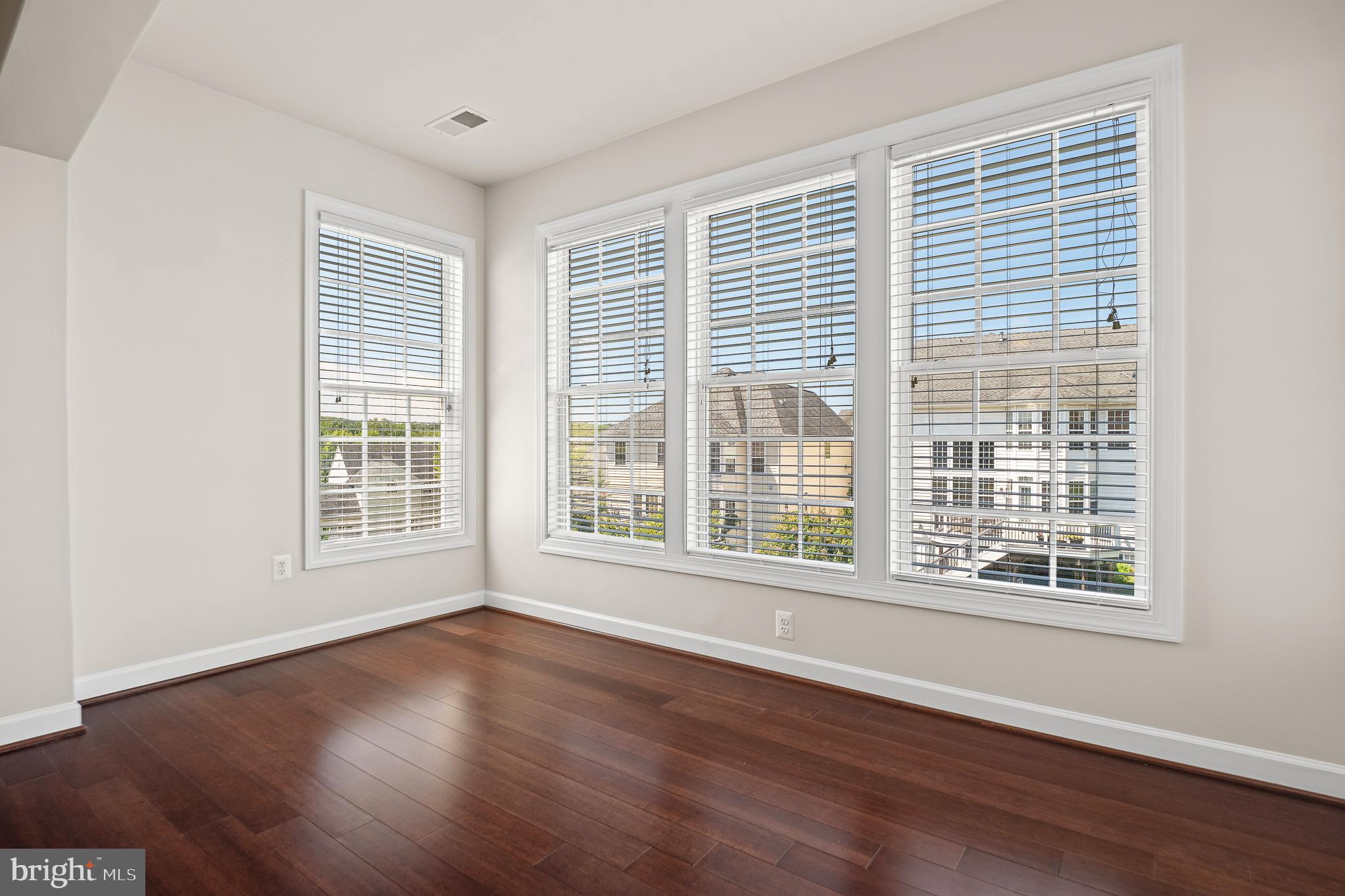 16862 Reef Knot Way Woodbridge, VA 22191 - Photo 43 of 99 a view of an empty room with wooden floor and a window