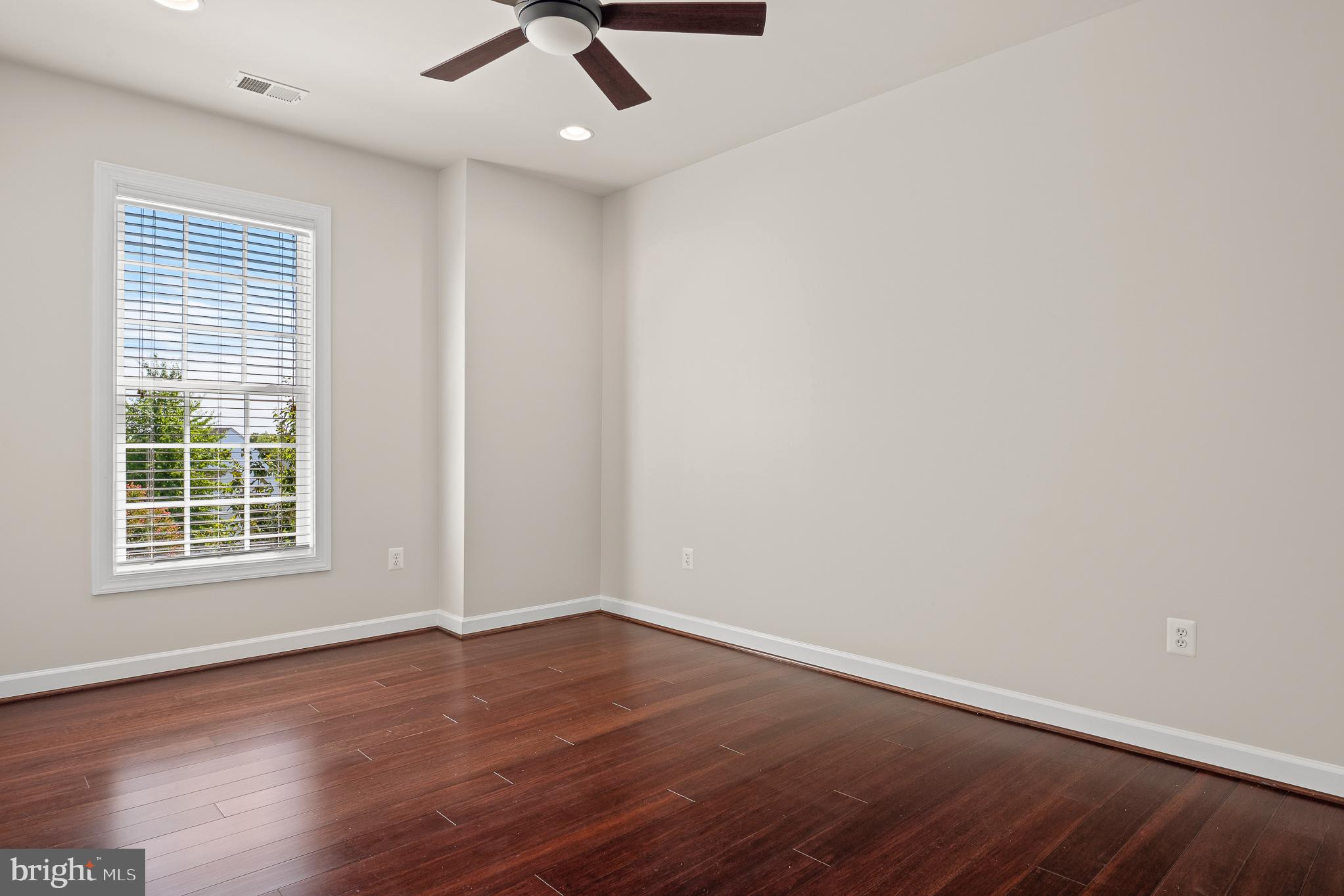 16862 Reef Knot Way Woodbridge, VA 22191 - Photo 57 of 99 an empty room with wooden floor fan and windows