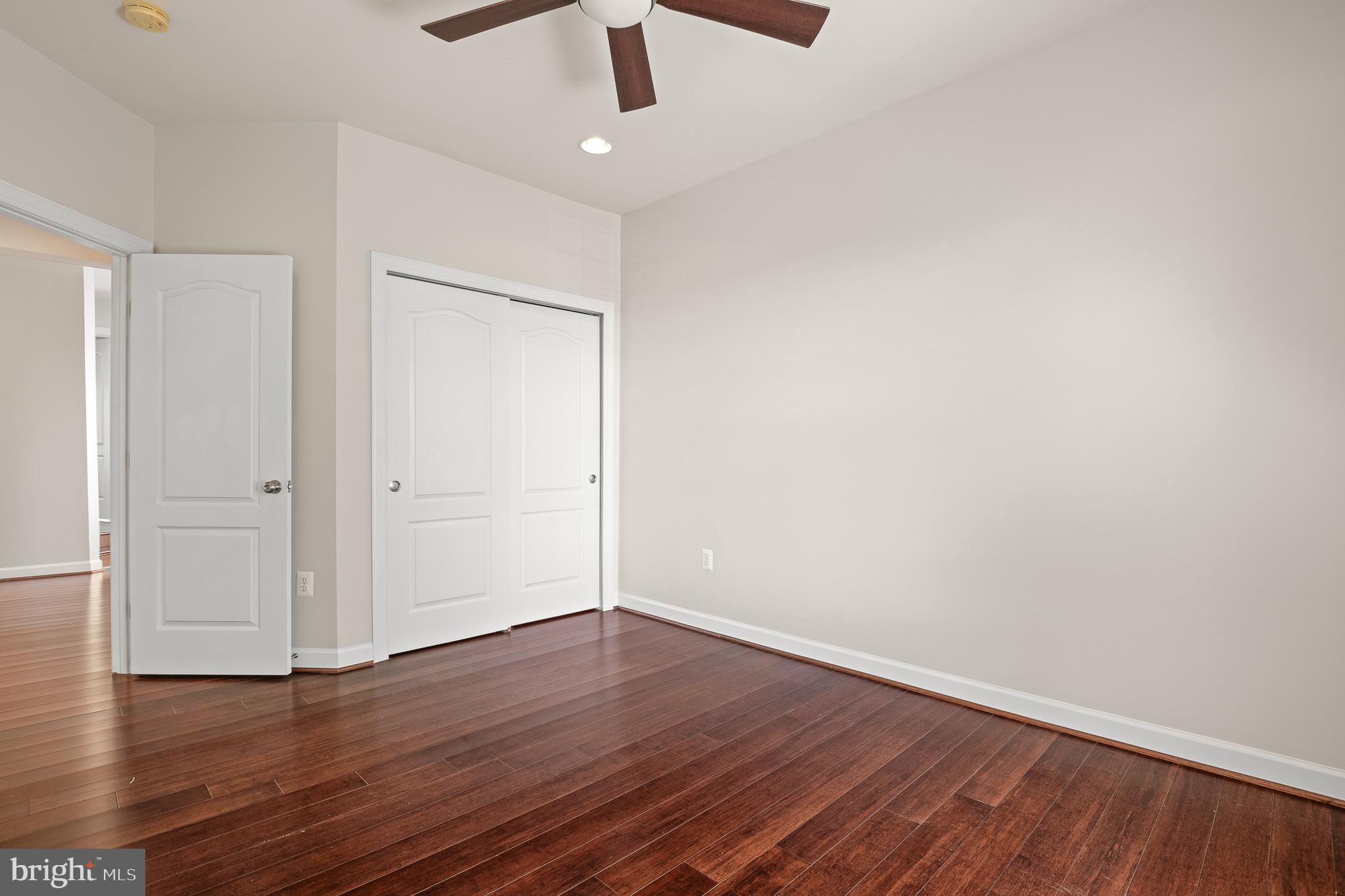 16862 Reef Knot Way Woodbridge, VA 22191 - Photo 60 of 99 an empty room with wooden floor ceiling fan and window
