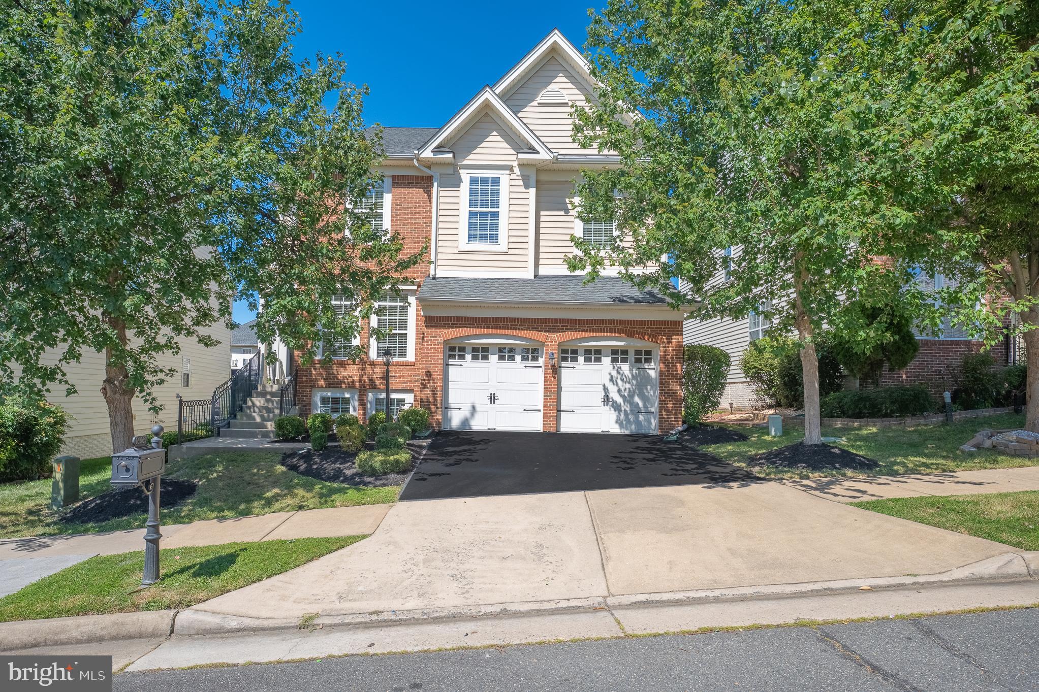 16862 Reef Knot Way Woodbridge, VA 22191 - Photo 79 of 99 a front view of a house with a yard and garage