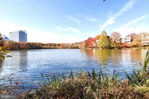 a view of a lake with houses in front of it