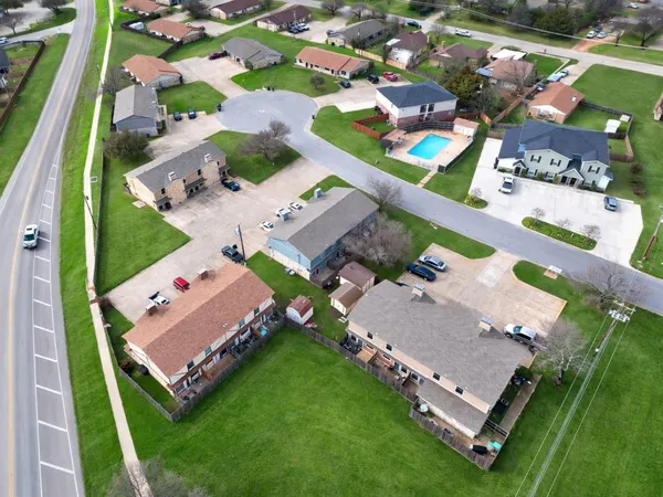 an aerial view of a pool yard outdoor seating and outdoor kitchen view