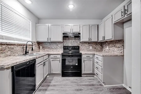 a kitchen with stainless steel appliances granite countertop a stove and a sink