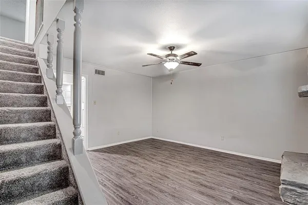 a view of an entryway with wooden floor and a chandelier