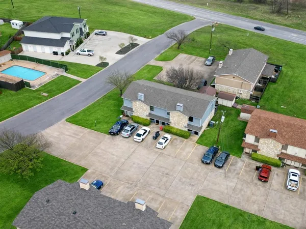 an aerial view of a house with garden space and street view