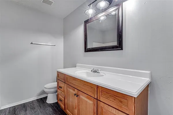 a bathroom with a sink toilet and mirror