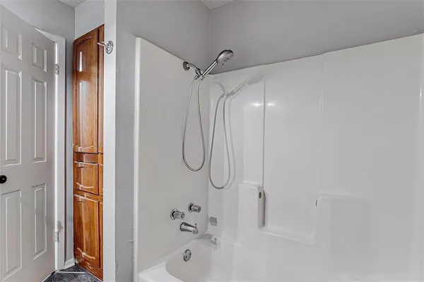 a bathroom with a bath tub and shower