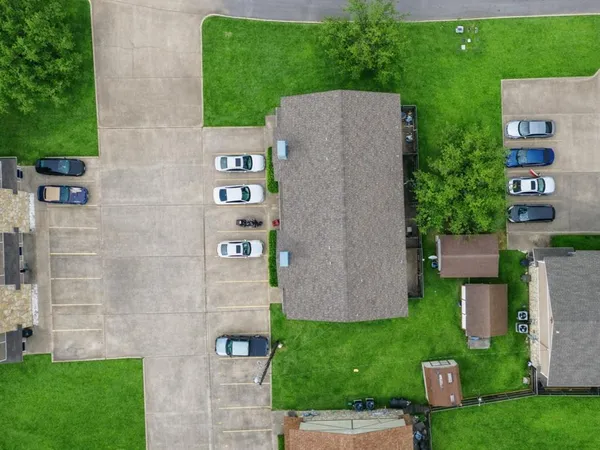 a aerial view of a house with a yard and a sitting area