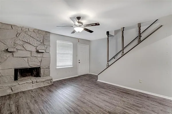 a living room with wooden floor a fireplace