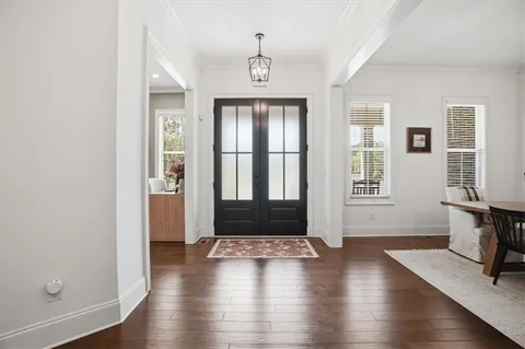 wooden floor in a hall with an entryway door