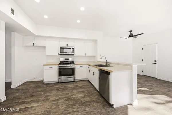 a kitchen with a sink stove and refrigerator