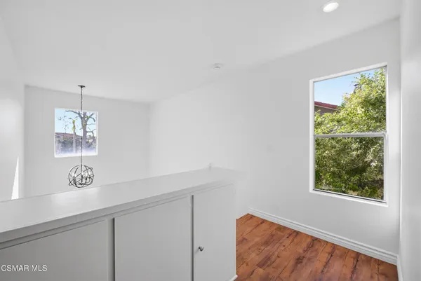 a view of an entryway with wooden floor