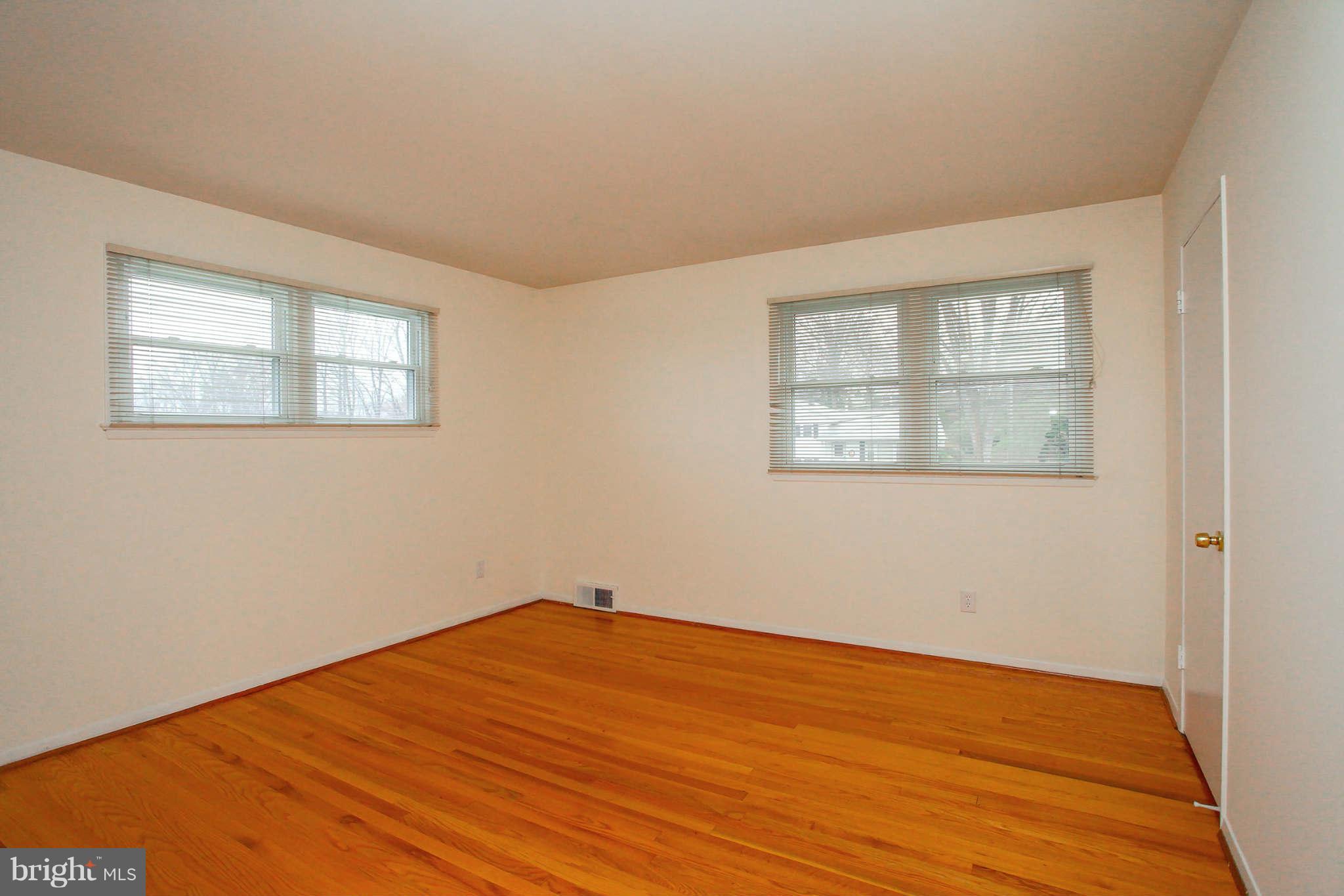 5917 Atteentee Road Springfield, VA 22150 - Photo 11 of 30 a view of an empty room with wooden floor and a window
