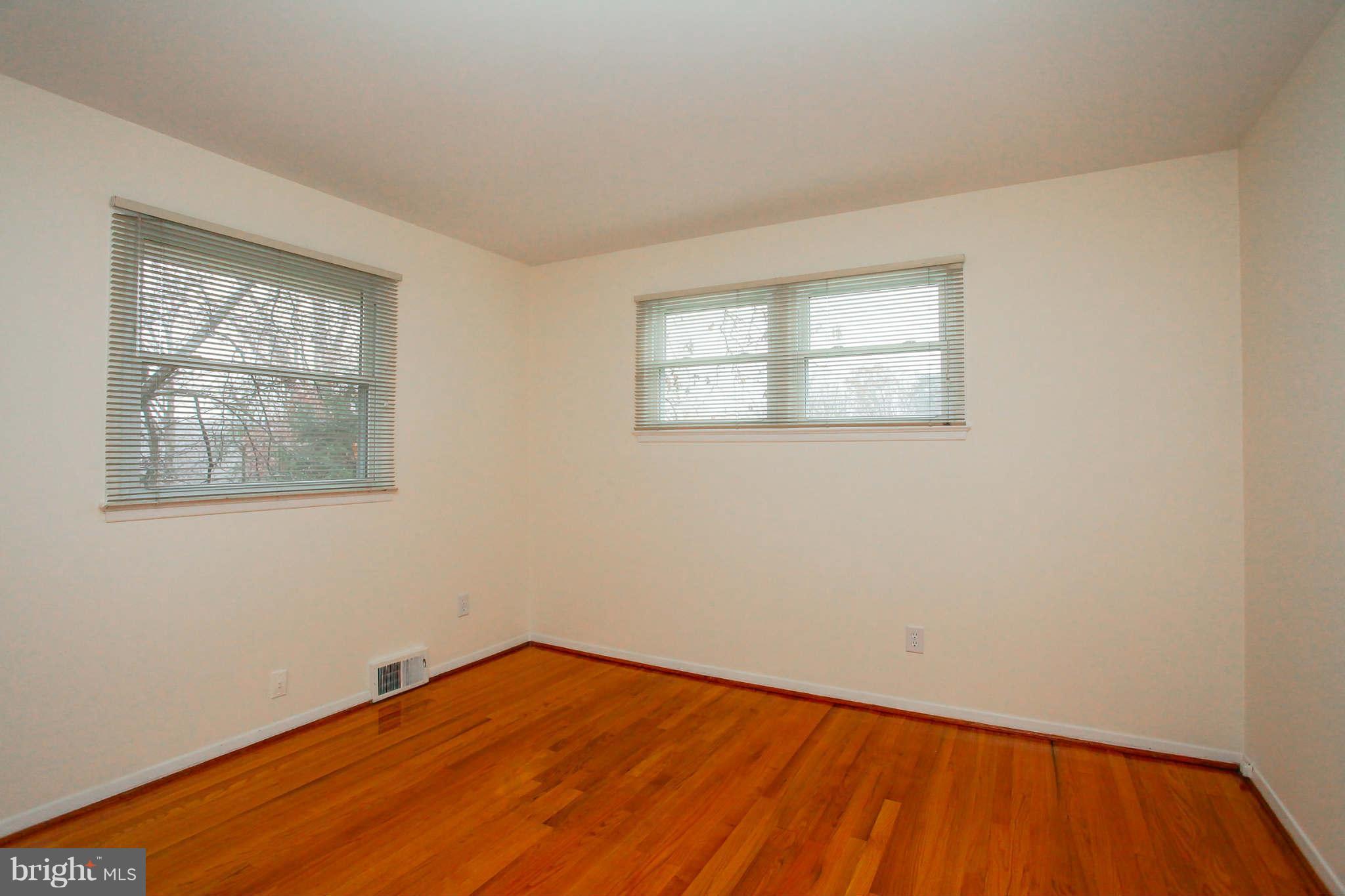 5917 Atteentee Road Springfield, VA 22150 - Photo 13 of 30 a view of empty room with wooden floor and fan