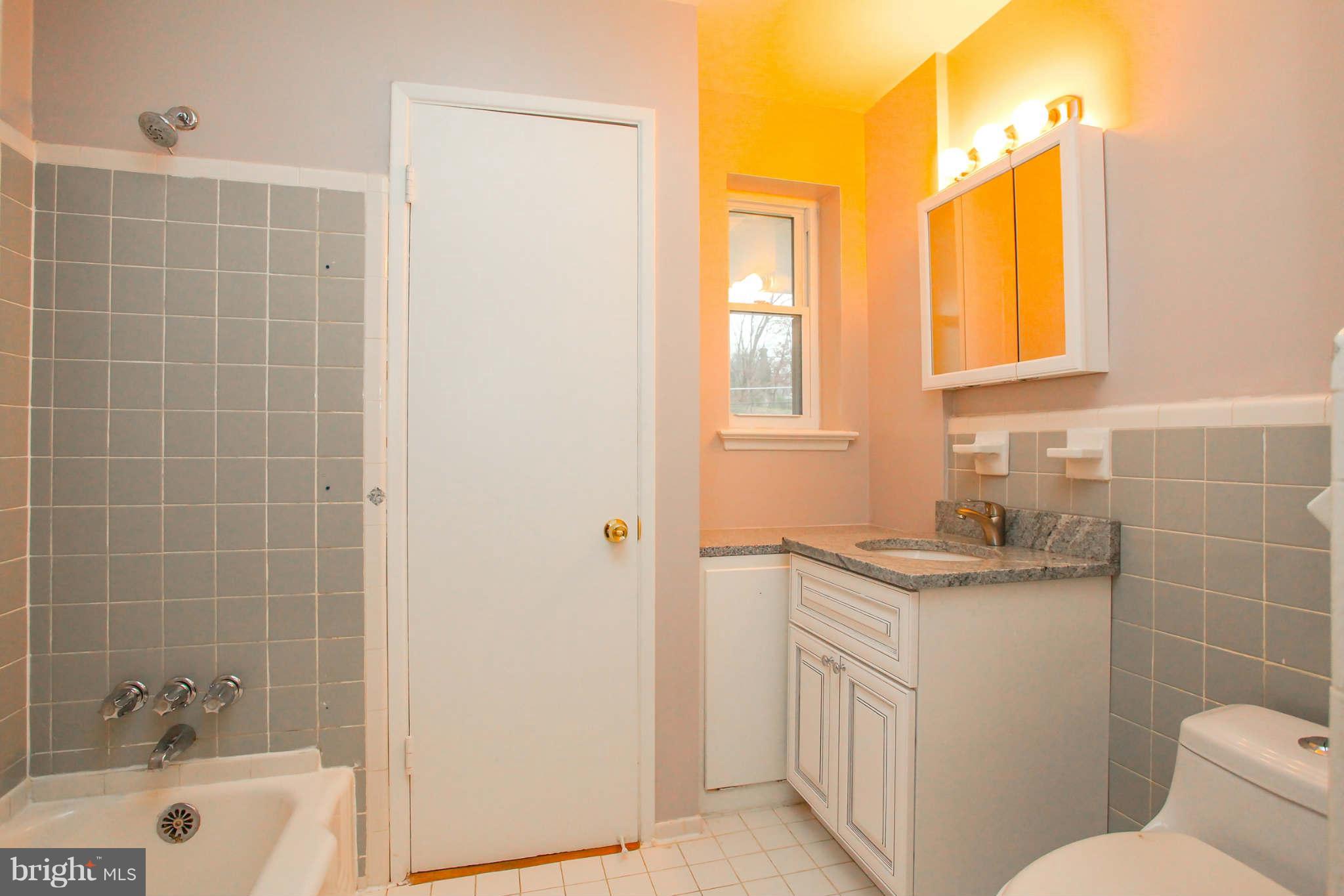 5917 Atteentee Road Springfield, VA 22150 - Photo 15 of 30 a bathroom with a granite countertop sink toilet and shower