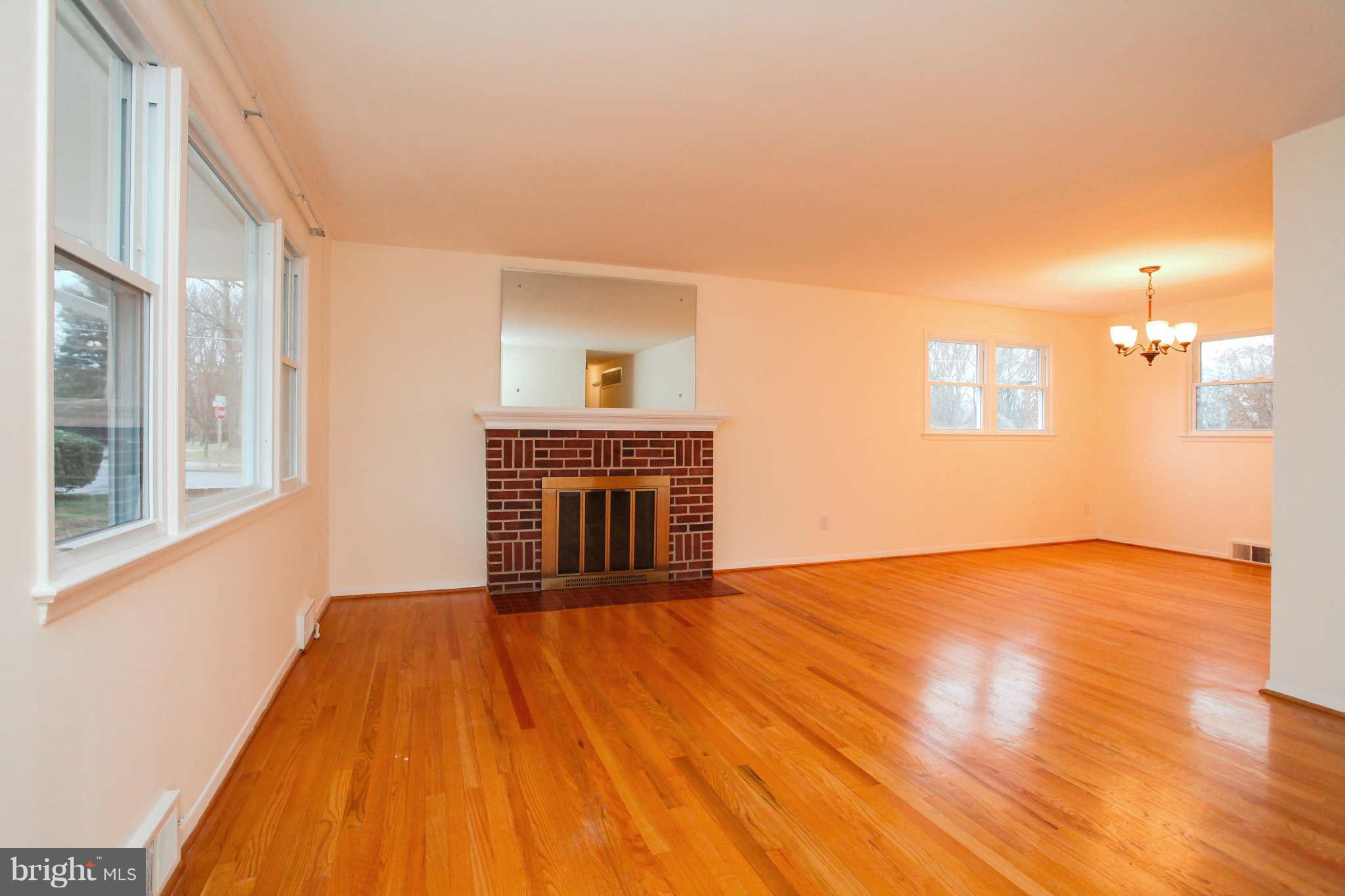 5917 Atteentee Road Springfield, VA 22150 - Photo 5 of 30 a view of empty room with wooden floor and fireplace