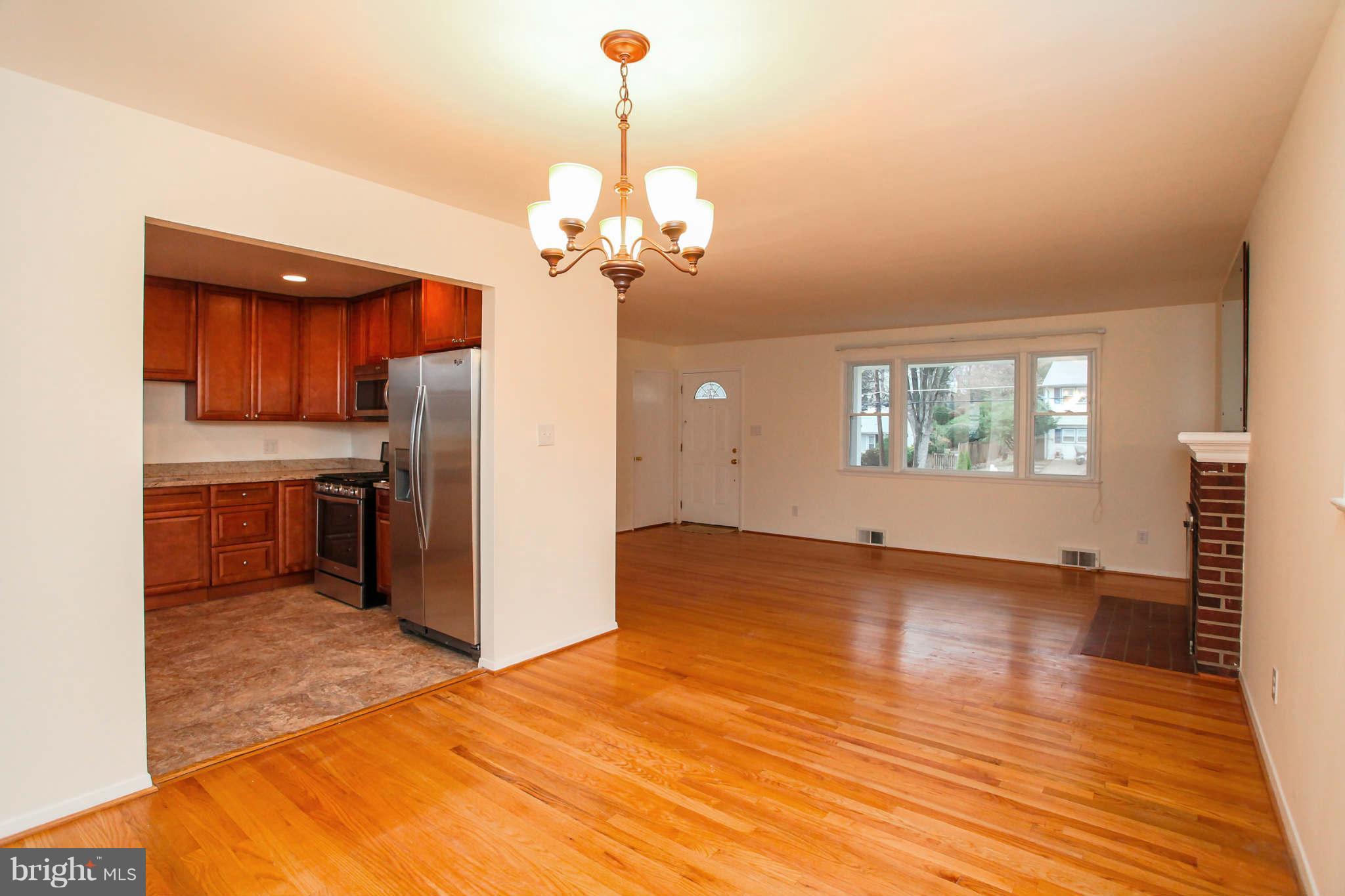 5917 Atteentee Road Springfield, VA 22150 - Photo 7 of 30 a view of a kitchen with stainless steel appliances granite countertop a refrigerator a stove and a wooden floors