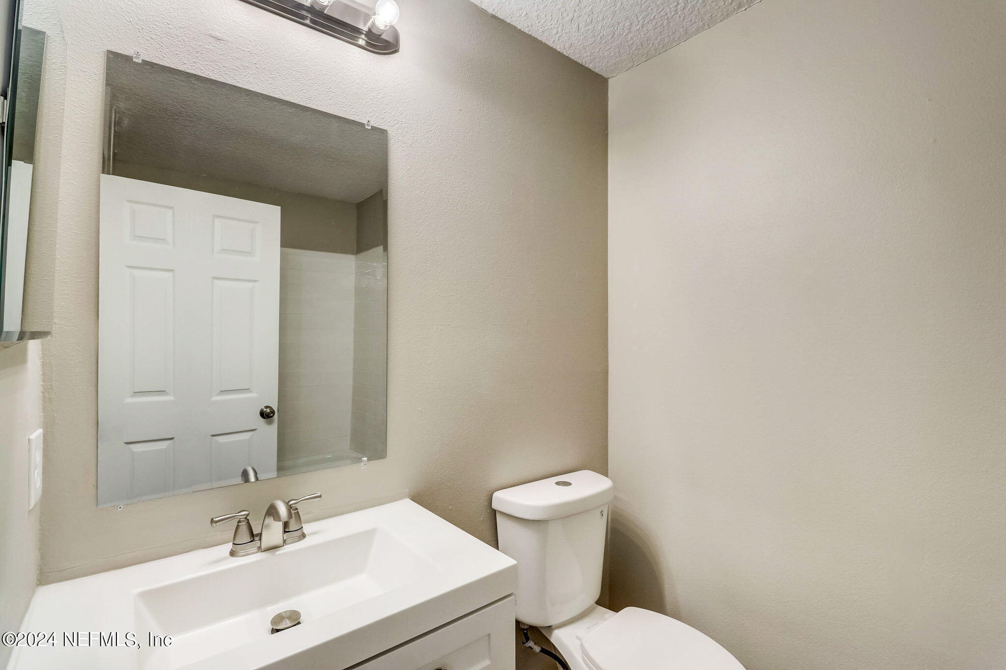 794 Bent Baum Road Jacksonville, FL 32205 - Photo 7 of 13 a bathroom with a sink mirror vanity and a toilet