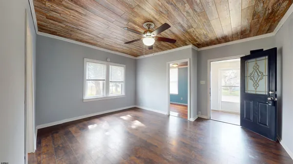 an empty room with wooden floor and cabinet
