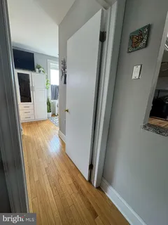 a view of hallway with wooden floor