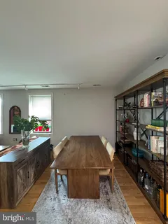a living room with furniture a window and bookshelf