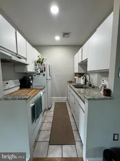 a kitchen with a stove and a sink