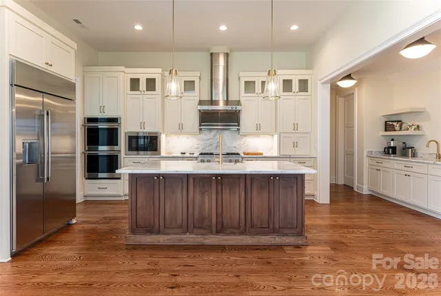 a bathroom with a granite countertop sink and a window