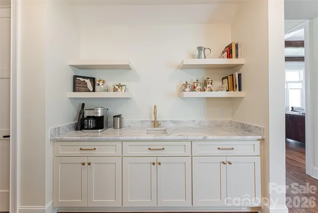 a bathroom with a double vanity sink a mirror and a toilet