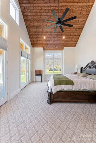 a spacious bedroom with a bed and a large window