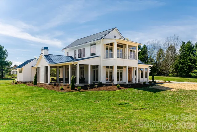 a front view of a house with a yard table and chairs