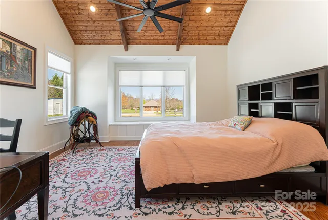 a bed sitting in a bedroom next to a window