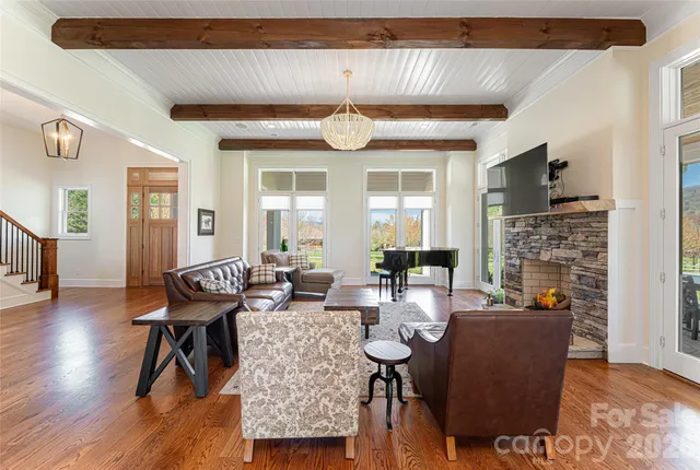 a living room with fireplace furniture and a flat screen tv