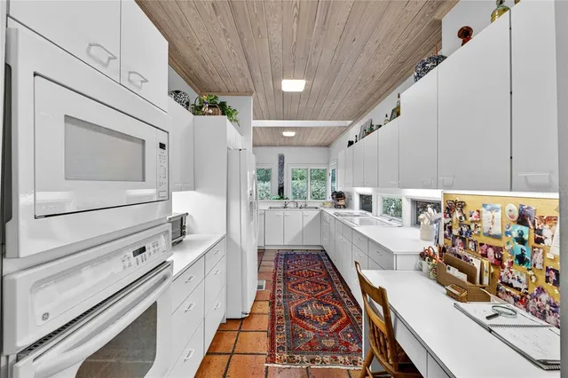 a spacious bathroom with a double vanity sink large mirror and a bathtub