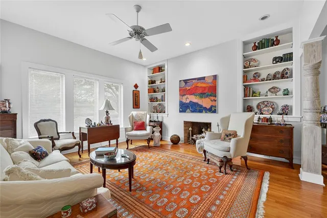 a living room with furniture a fireplace and a large window