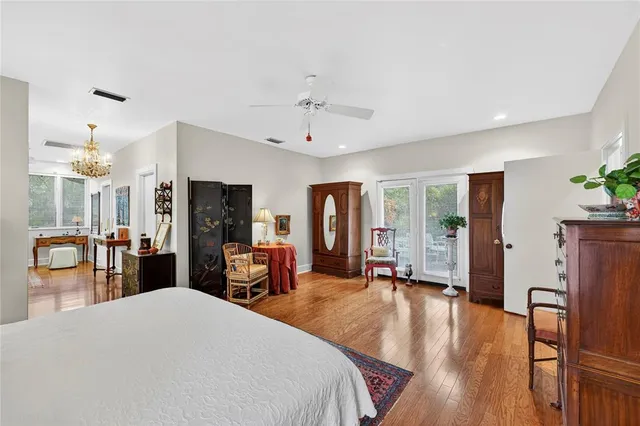 a bedroom with a bed and dresser with mirror