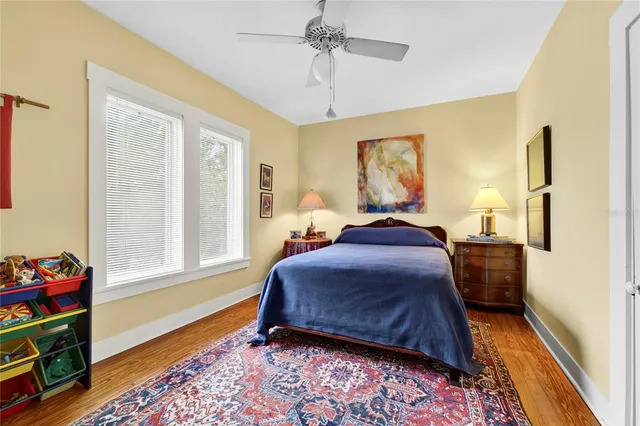 a view of a house with potted plants and a car parked