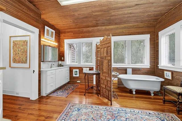 a view of a house with a yard and large trees