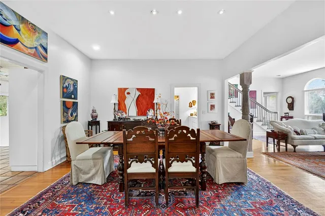 a living room with furniture kitchen view and a window