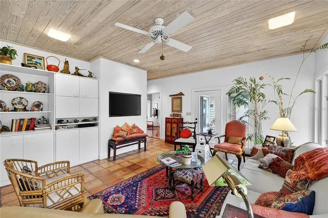 a dining room with furniture and large windows