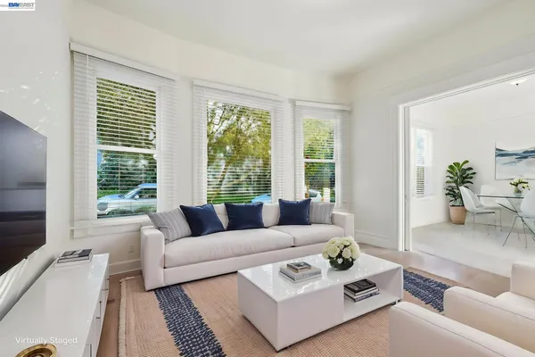 a living room with furniture and large windows