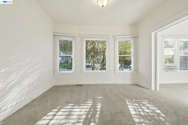 a view of a livingroom with wooden floor and a window