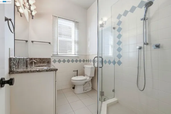 a bathroom with a sink vanity and a mirror