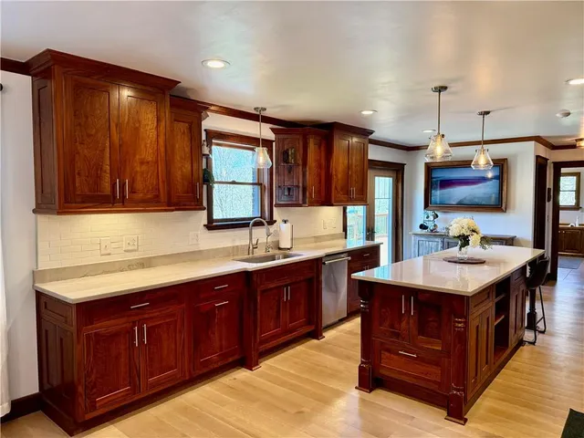 a kitchen with a sink and a wooden cabinets