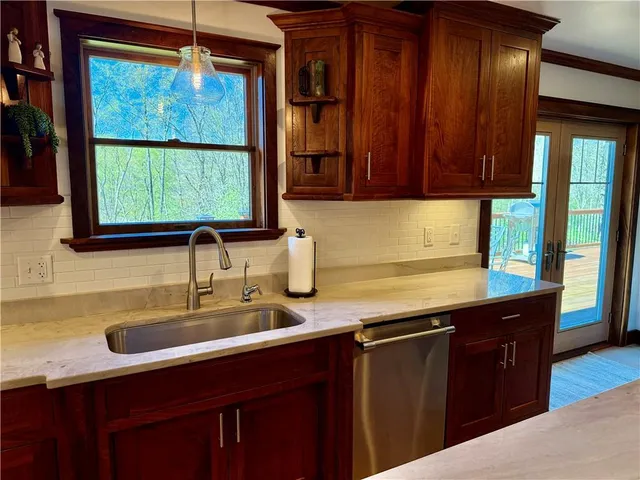 a kitchen with a sink window and cabinets